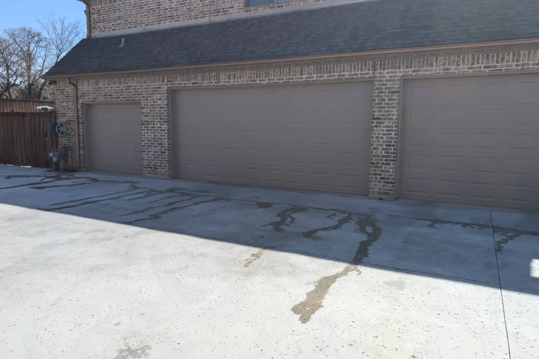 Wide concrete drive serving a multi-bay garage building